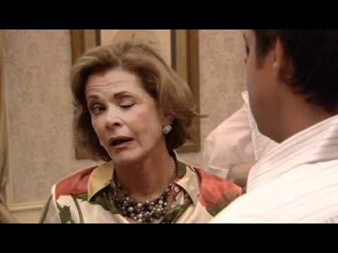 Lucille Bluth, from Arrested Development, winking grotesquely