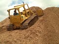 Caterpillar D5 Dozer Moving Mulch up a hill