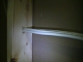 Drilling holes in a stud wall.