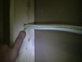 Drilling holes in a stud wall.
