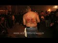 Young Muslim boys flagellate themselves during the procession of Chup Tazia