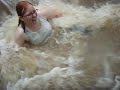 Melissa Burns goes sliding at floodstage at Wildlife Wonders ZOO.