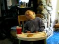Funny sleeping baby in high chair