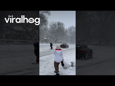 Lamborghini Huracan Pulling a Skier Down Snow-Covered Street || ViralHog