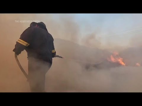 Raging wildfires force evacuation in South African coastal village