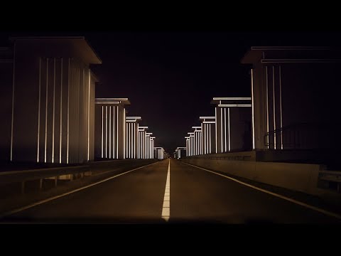 Restored floodgates by Studio Roosegaarde light up in the headlights of passing cars