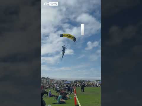 Moment parachutist lands on spectators
