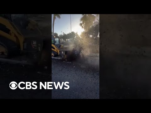 Crews in Sarasota, Florida, remove mud left by Hurricane Milton