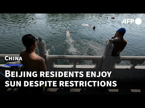 Beijing residents have fun in the sun despite tightening restrictions | AFP