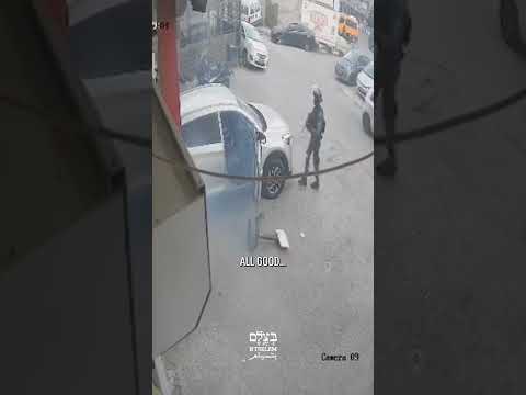 Israeli police officer throwing a stun grenade into a Palestinian vehicle in Qalandiya camp, 5.7.26