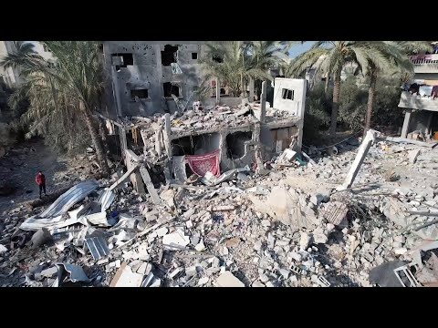 Drone shows damage caused by strikes in central Gaza, displaced people crowd streets