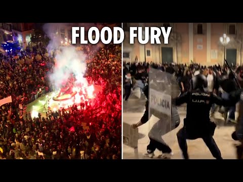 Riot cops clash with raging protesters hurling flares in Spain as anger erupts over flood deaths