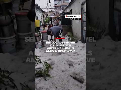 See locals shovel ice in Mexico after hail falls amid a heat wave