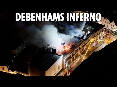 Flames engulf old Debenhams sending smoke billowing into air as dozens of firefighters battle blaze