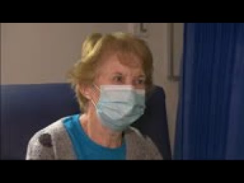 First UK vaccine patient reacts after receiving jab