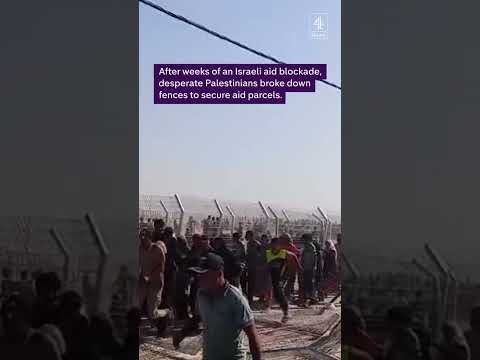 Thousands of Palestinians have stormed a controversial new aid depot in Gaza