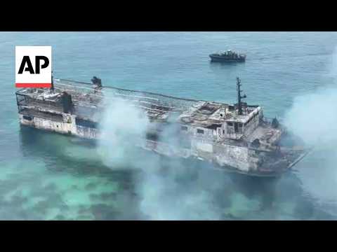 Smoldering remains of Philippine ferry after fire kills 5 with dozens missing