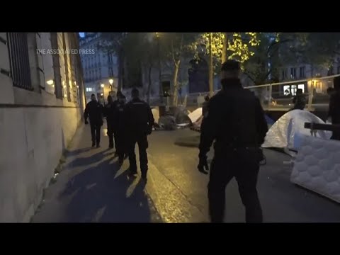 French police evict migrants from a makeshift camp in Paris ahead of Olympics