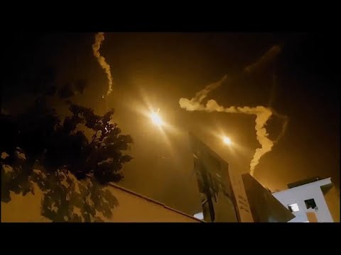 Flares and blasts light up night sky over Gaza City as Israeli forces prepare to move in