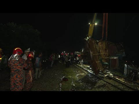 Emergency workers at scene outside Bangladesh capital where cargo train hit passenger train