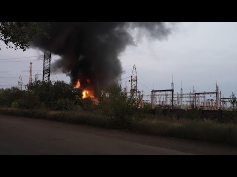 Ukrainian emergency workers extinguish flames of burning electrical substation hit by Russian bombin