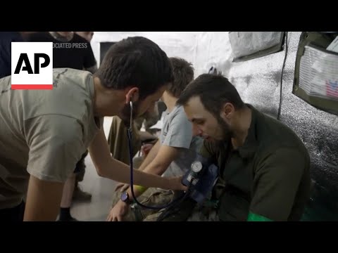 Ukrainian military medics treat injured fighters of Azov Brigade near frontline