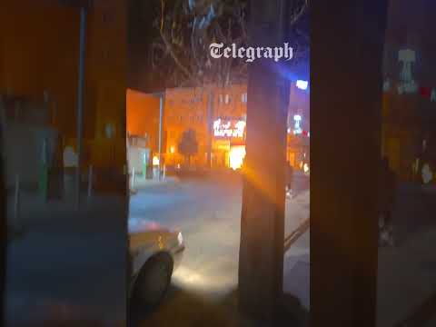 Moment fires ignite in Tehran street after Israel bombs oil depots