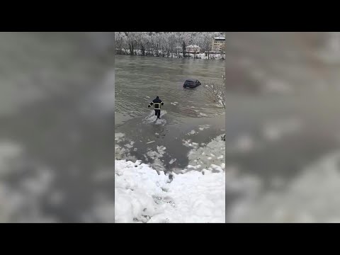 Bosnian firefighter saves car from freezing river after flooding | AFP