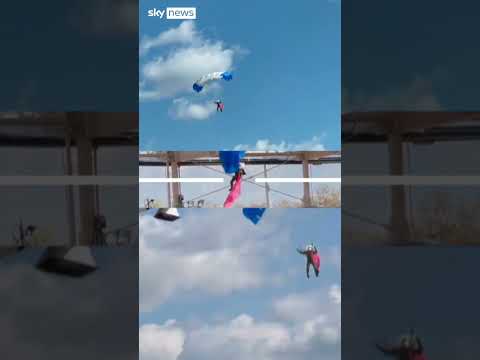 Parachutist snagged on stadium roof