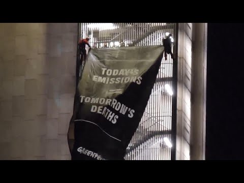 Greenpeace climbs oil company building in Rome to protest against fossil fuels