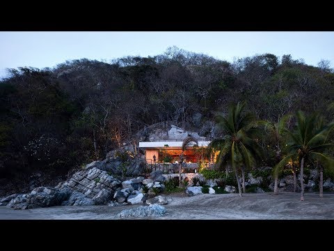 Cabana and pool by CDM cut into rocky slope on Mexico's coast