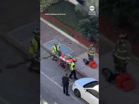 Driver rescued from car dangling from parking garage