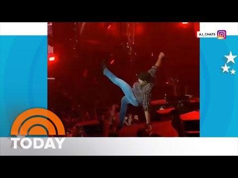 Luke Bryan slips on fan’s cellphone during performance