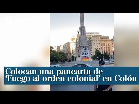 Cien personas colocan una pancarta de Fuego al orden colonial en la estatua de Colón de Madrid