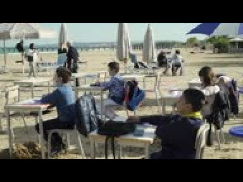 Pupils attend classes at the beach during pandemic