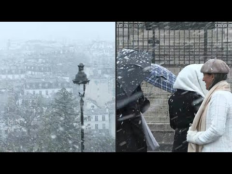 Tourists and Parisians stroll through Montmartre in the snow | AFP