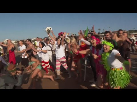 Portuguese beachgoers take a dip in the Atlantic on New Year's day