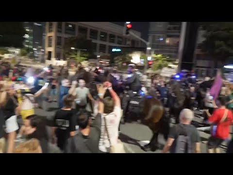 Minor scuffles break out in Tel Aviv between police and anti-government protesters demanding a hosta