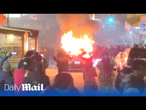 Angry crowd destroys driverless Waymo robotaxi in San Francisco with fireworks and skateboards