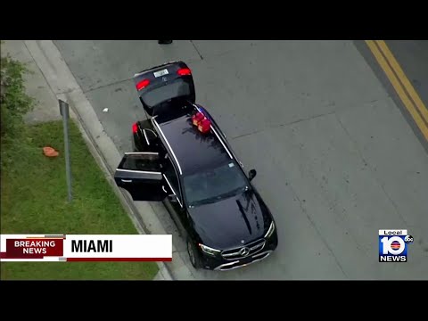 Police officers surround car outside hospital in Miami