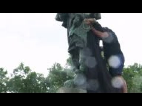 Activists cover statue of French military commander