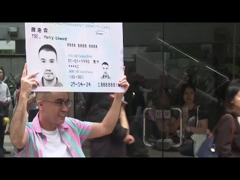 Transgender activist Henry Tse receives his new Hong Kong identity card