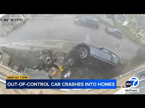 Shocking moment speeding BMW skids across road, crashes into homes