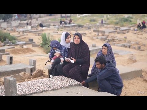 Grieving relatives spend the first morning of Eid al-Fitr at Deir Al-Balah cemetery