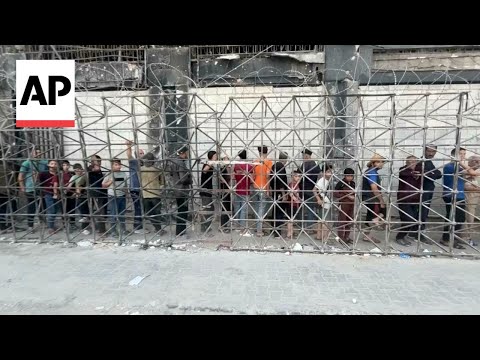 Desperate Palestinians line up for bread in Gaza City amid famine warning
