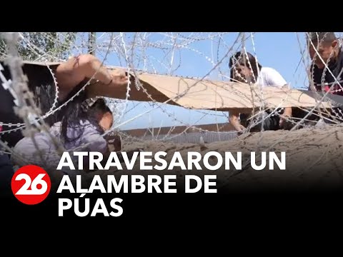 Migrante venezolana y su hija atraviesan un alambre de púas para llegar a EEUU