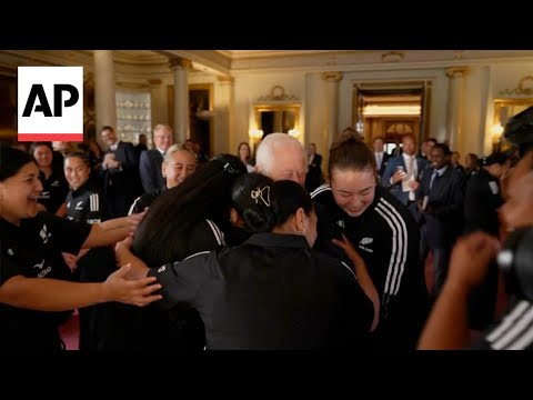 King Charles gets a group hug from the New Zealand women's rugby team