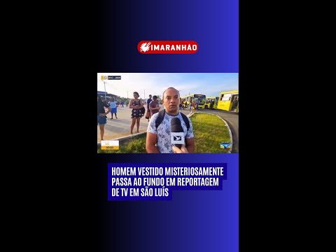 HOMEM VESTIDO DE FORMA MISTERIOSA APARECE EM REPROTAGEM, NO FUNDO