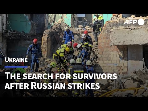 Rescue workers search for victims after Kyiv strikes | AFP