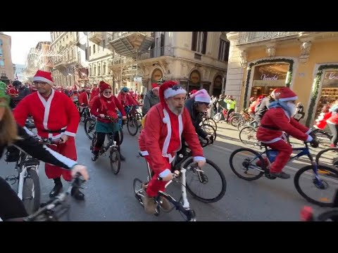 Hundreds of cyclists dressed as Santa join charity bike ride through historic streets of Rome